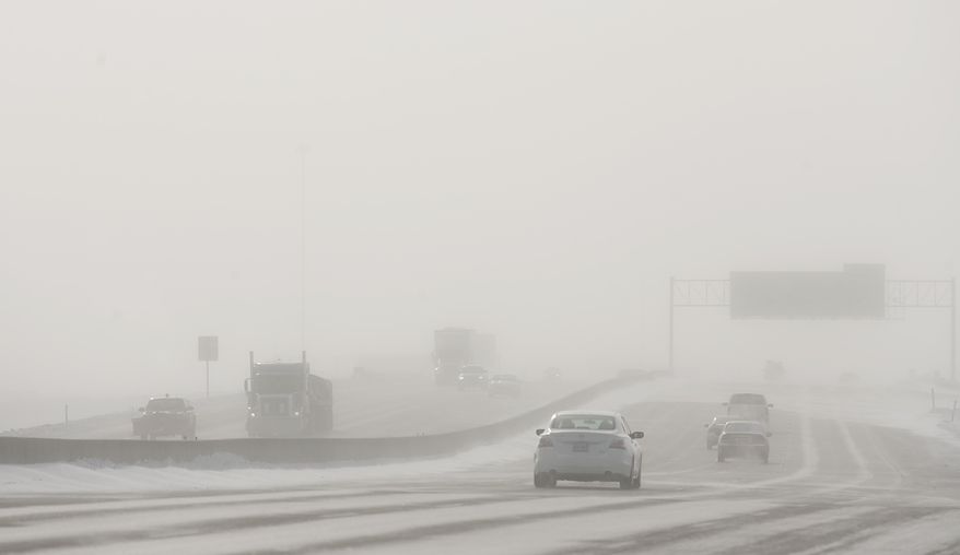 Drivers on Interstate 29 encounter blowing snow, reduced visibility on Wednesday, Jan. 22, 2014 in Fargo, N.D. Some schools and offices closed Wednesday and motorists struggled to get to their destinations as the second blizzard in less than a week tore through the Red River Valley of eastern North Dakota. The National Weather Service issued a blizzard warning for eastern North Dakota through Wednesday afternoon. Transportation officials early Wednesday advised motorists to use caution in eastern and south central North Dakota. A no-travel advisory was issued for northeastern North Dakota but lifted midmorning. (AP Photo/Bruce Crummy)