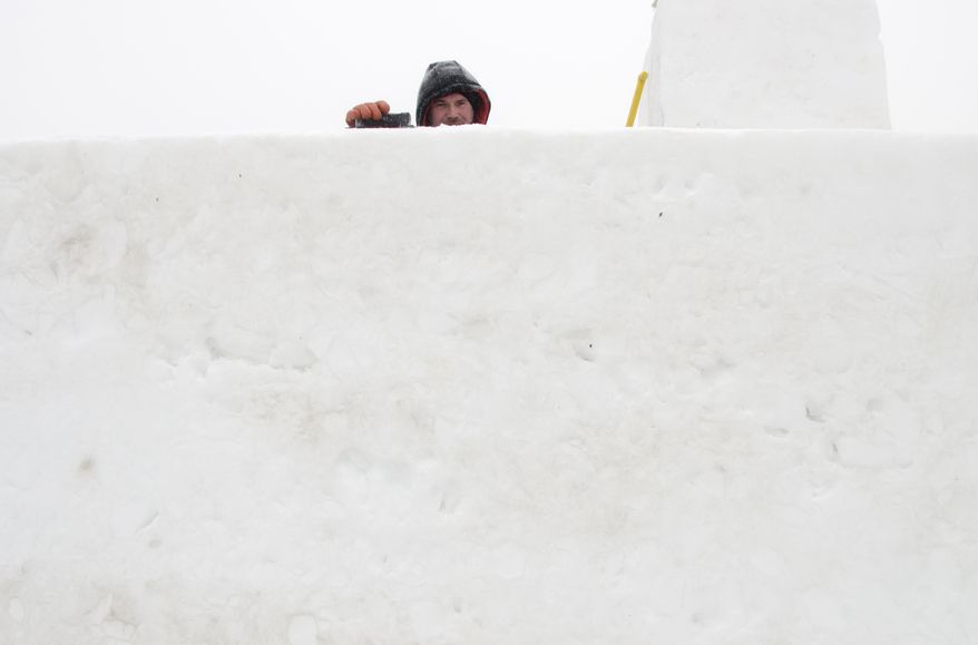Jeremie Magnan, of Team France, works on their sculpture during the World Class Snow Sculpting Competition at Zehnder's Snowfest in Frankenmuth, Mich., on Wednesday, Jan. 22, 2014. Bitter cold is lingering across Michigan, with readings below zero and more snow forecast for parts of the state. (AP Photo/The Saginaw News, Tim Goessman ) ALL LOCAL TV OUT; LOCAL TV INTERNET OUT