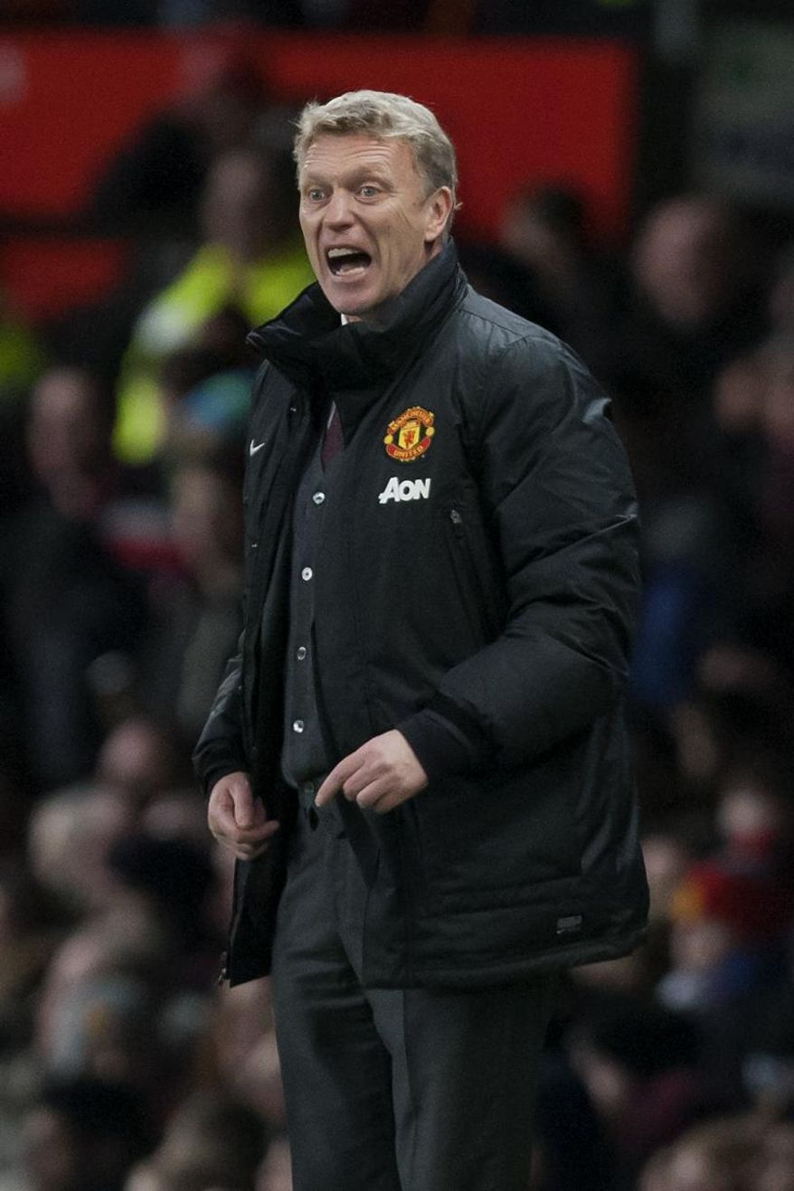 Manchester United's manager David Moyes issues instructions during his team's English League Cup semifinal second leg soccer match against Sunderland at Old Trafford Stadium, Manchester, England, Wednesday Jan. 22, 2014. (AP Photo/Jon Super)