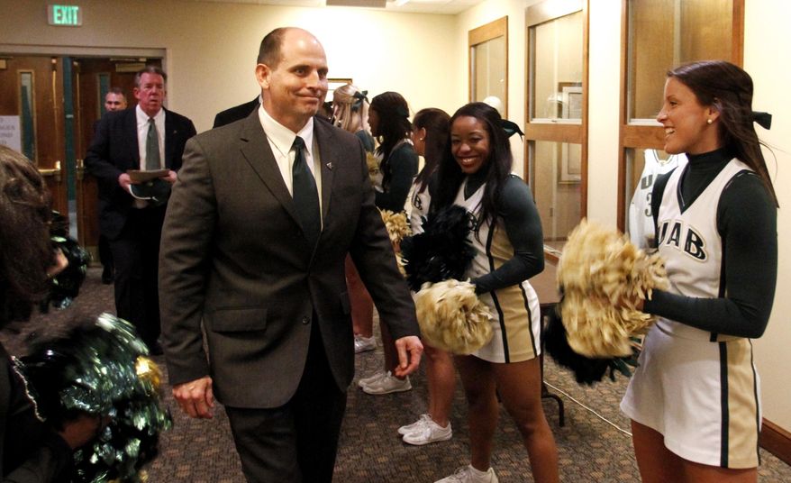 Bill Clark is introduced as the new UAB NCAA college football head coach Wednesday, Jan. 22, 2014, in Birmingham, Ala. Clark led Jacksonville State to its most victories since the Gamecocks' Division II champion team in 1992 during his lone season. Jacksonville State went 11-4 and advanced to the FCS quarterfinals. (AP Photo/Butch Dill)