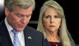 Maureen McDonnell looks on as her husband, former Virginia Gov. Bob McDonnell, made a statement on Tuesday after the couple was indicted on corruption charges. (associated press)