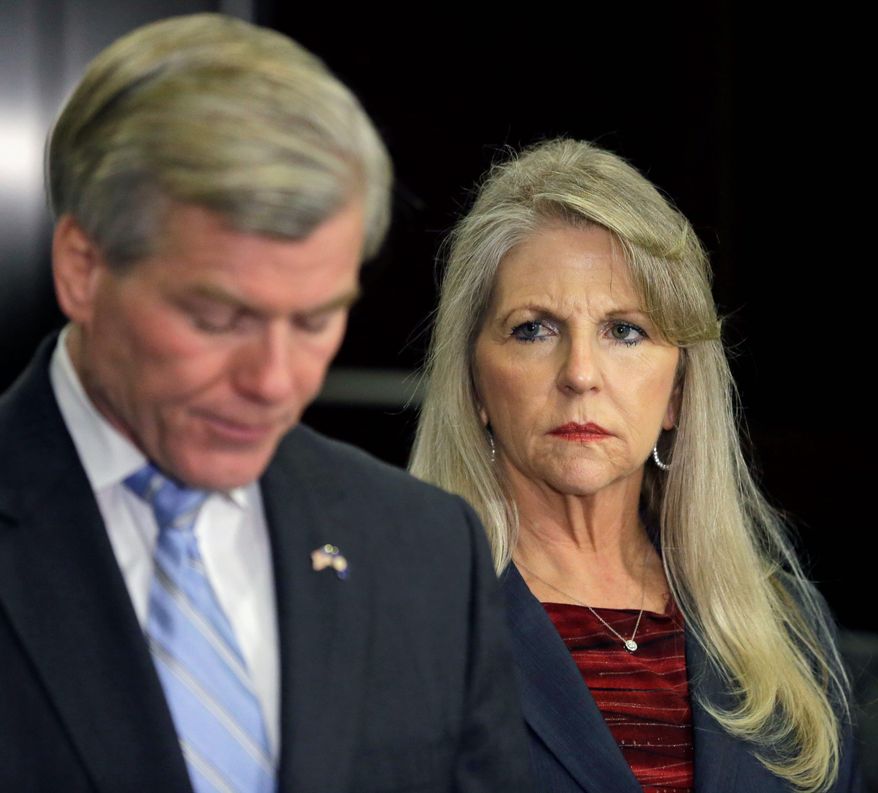 Maureen McDonnell looks on as her husband, former Virginia Gov. Bob McDonnell, made a statement on Tuesday after the couple was indicted on corruption charges. (associated press)
