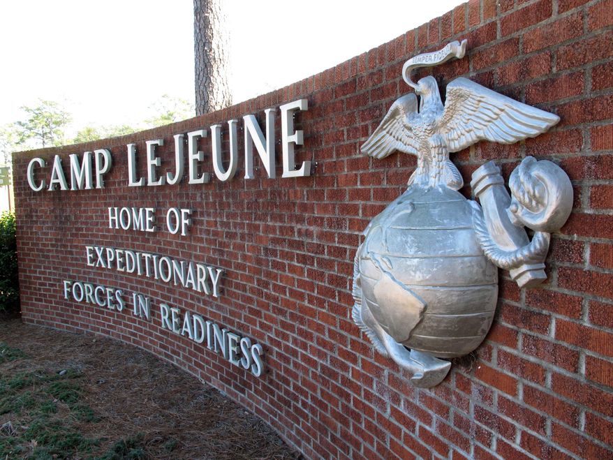 FILE - This March 19, 2013 photo shows the globe and anchor stand at the entrance to Camp Lejeune, N.C. An explosion that killed seven Camp Lejeune Marines during a nighttime training exercise on March 18, 2013, was the result of human error and insufficient training, according to the results of a military investigation. Lt. Adam Flores, a spokesman for the Lejeune-based 2nd Marine Division, said Wednesday, Jan. 22, 2014 that the investigation found the deadly March 18 explosion was triggered when a Marine dropped a second round into an already loaded mortar tube during a live-fire exercise. Two officers and a noncommissioned officer were relieved of command following the explosion at Hawthorne Army Depot in Nevada. (AP Photo/Allen Breed, File)