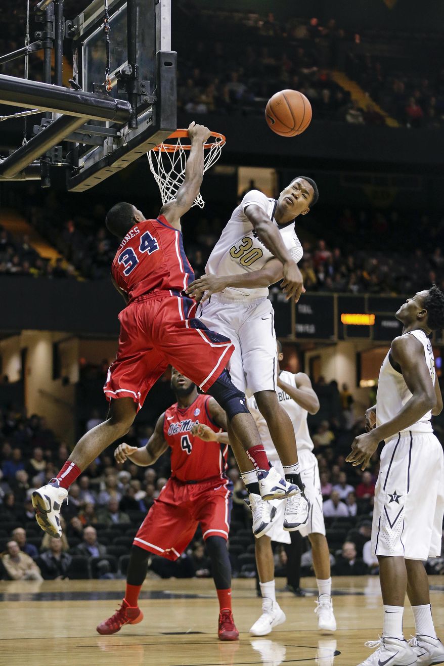 Vanderbilt center Damian Jones (30) blocks a shot by Mississippi forward Aaron Jones (34) in the first half of an NCAA college basketball game Wednesday, Jan. 22, 2014, in Nashville, Tenn. (AP Photo/Mark Humphrey)