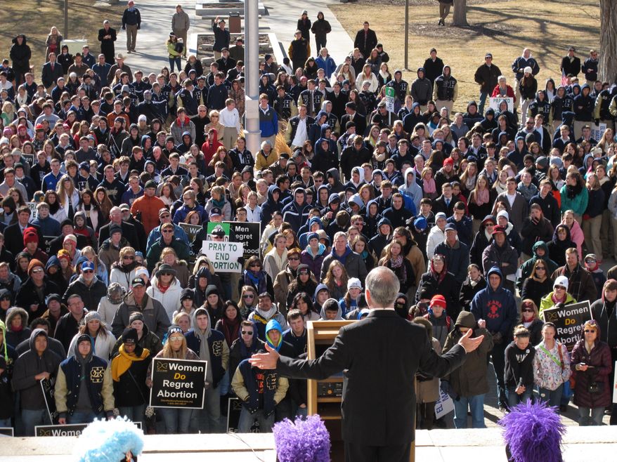 Hundreds of abortion opponents rally outside the Kansas Statehouse and hear a speech by U.S. Rep. Tim Huelskamp, Wednesday, Jan. 22, 2014, in Topeka, Kan. The demonstrators were marking the anniversary of the U.S. Supreme Court decision legalizing abortion across the nation. (AP Photo/John Hanna)