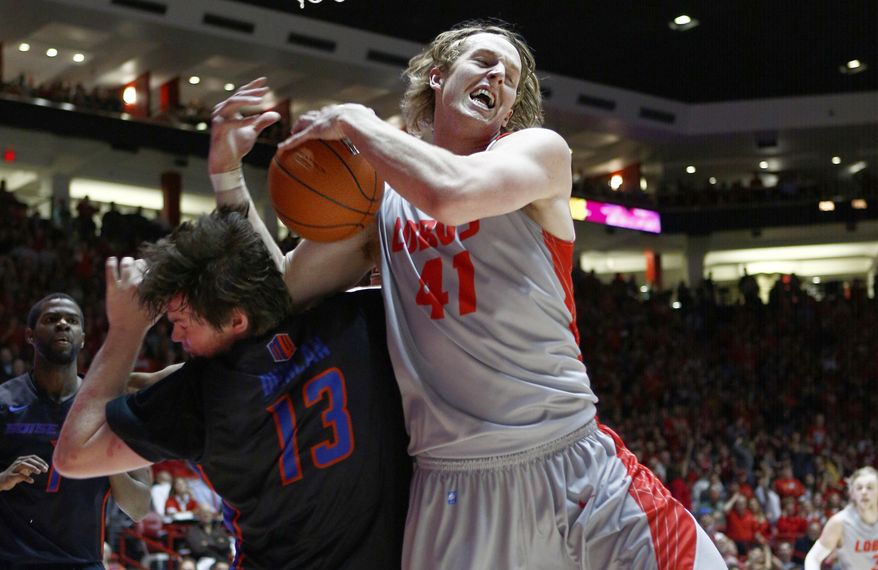 New Mexico's Cameron Bairstow (41) rebounds over Boise State's Nick Duncan (13) during the second half of an NCAA college basketball game in Albuquerque, N.M., Tuesday, Jan. 21, 2014. New Mexico won 84-75. (AP Photo/Juan Antonio Labreche)