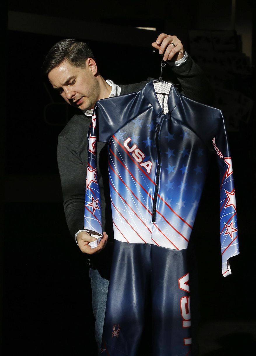 Spyder Active Sports Inc., production art manager Matt Strackbein holds up a downhill racing suit of the design to be worn by the U.S. Alpine ski team at the Winter Olympics in Sochi, at Spyder headquarters in Boulder, Colo., Wednesday Jan. 22, 2014. According to Strackbein, the suits' colors are meant to represent the reflection of the U.S. flag on Chesapeake Bay following the bombardment of Fort McHenry during the War of 1812. The bombardment witnessed by Francis Scott Key inspired the lyrics to "The Star-Spangled Banner." (AP Photo/Brennan Linsley)