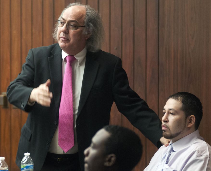 In this photo from Jan. 21, 2014, defense attorney James Piazza, for Rico Saldana, right, makes a point to the jury during his closing argument in the trial for Saldana, 22, right, and Michael Lawrence, 24, in front, in Saginaw, Mich. On Wednesday, Jan. 22, a jury convicted the men with first-degree murder and multiple other felonies in the Aug. 29, 2012, drive-by shooting death of 6-year-old Lay'la Jones. (AP Photo/The Saginaw News, Jeff Schrier) ALL LOCAL TV OUT; LOCAL TV INTERNET OUT.