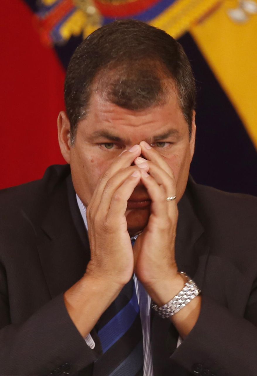 Ecuador's President Rafael Correa gestures as he meets with the foreign press at the government palace in Quito, Ecuador, Wednesday, Jan. 22, 2014. Correa, who was first elected in January 2007, said the U.S. government and his are going through tension and mutual distrust, clarifying that he personally likes the U.S. where he earned two university degrees. (AP Photo/Dolores Ochoa)