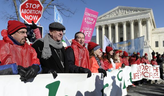 Protestor lead the annual March for Life Rally near the Supreme Court in Washington, Wednesday, Jan. 22, 2014. Thousands of abortion opponents are facing wind chills in the single digits to rally and march on Capitol Hill to protest legalized abortion, with a signal of support from Pope Francis. (AP Photo/Susan Walsh)