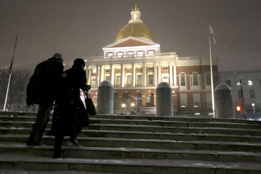 Passers-by ascend snow-covered stairs near the Statehouse, Tuesday, Jan. 21, 2014, in Boston. Heavy snow has been forecast and a blizzard warning was posted for portions of Massachusetts Tuesday, prompting Gov. Deval Patrick to dismiss nonemergency state workers early and postpone his annual State of the State address. (AP Photo/Steven Senne)