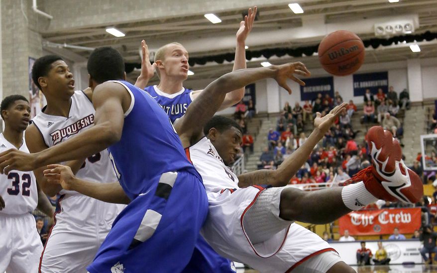 The ball gets away as Duquesne's Ovie Soko, right, and Saint Louis' Dwayne Evans, left, and John Manning, center, chase a rebound during the first half of an NCAA college basketball game on Wednesday, Jan. 22, 2014, in Pittsburgh. (AP Photo/Keith Srakocic)