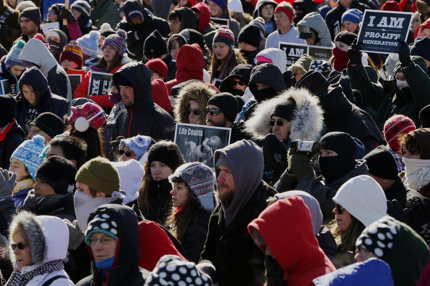 Anti-abortion demonstrators participate in the annual March for Life, Wednesday, Jan. 22, 2014, on the National Mall in Washington. Thousands of anti-abortion demonstrators are gathering in Washington for an annual march to protest the Supreme Court's landmark 1973 decision that declared a constitutional right to abortion. (AP Photo/Charles Dharapak)
