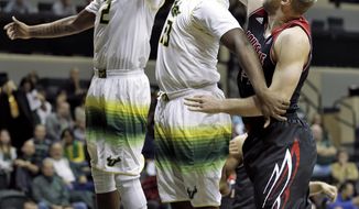 South Florida forward Chris Perry (23) grabs a rebound in front of teammate forward Victor Rudd (2) and Louisville forward Stephan Van Treese (44) during the first half of an NCAA college basketball game Wednesday, Jan. 22, 2014, in Tampa, Fla. (AP Photo/Chris O&#39;Meara)