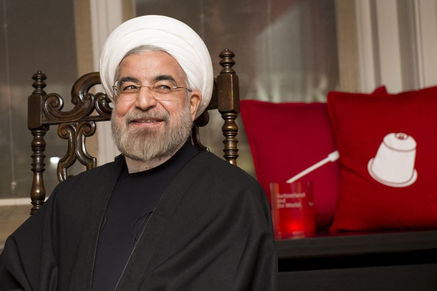 Iranian President Hassan Rouhani, smiles as he meets President of the Swiss Confederation Didier Burkhalter during a bilateral meeting on the sideline of the 44. Annual Meeting of the World Economic Forum, WEF, in Davos, Switzerland, Thursday, Jan. 23, 2014. (AP Photo/Keystone,Jean-Christophe Bott)