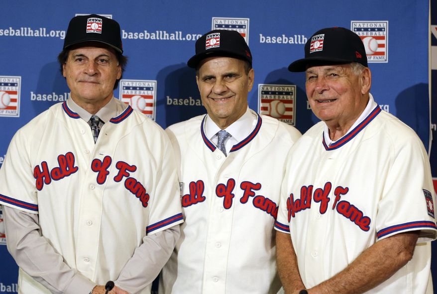 FILE - In this Dec. 9, 2013, file photo, retired managers, from left, Tony La Russa, Joe Torre and Bobby Cox gather for a photo after it was announced that they were unanimously elected to the baseball Hall of Fame during MLB winter meetings in Lake Buena Vista, Fla. La Russa will not have any logo on his cap in his Hall of Fame plaque, the Hall said Thursday, Jan. 23, 2014. Torre's will have a Yankees logo, while Cox's whill have a Braves logo.  (AP Photo/John Raoux, File)