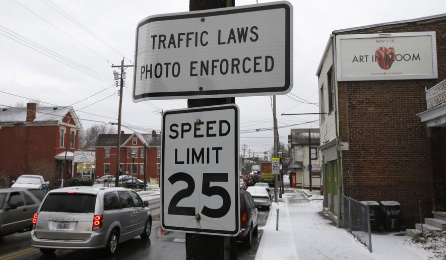 This photo made Thursday, Jan. 16, 2014, shows a sign advising motorists they may be monitored by traffic cameras in Elmwood Place, Ohio, after the cameras were removed by a ruling from Hamilton County Common Pleas Judge Robert Ruehlman. Judge Ruehlman ruled Thursday, Jan. 23 the village must refund nearly $1.8 million to drivers who received speeding camera tickets there, pending an appeal. (AP Photo/Al Behrman) **FILE**