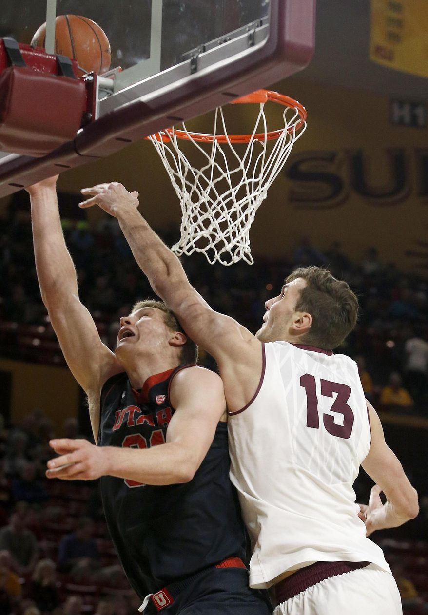 Arizona State's Jordan Bachynski (13) blocks the shot of his brother Utah's Dallin Bachynski during the first half of an NCAA basketball game Thursday, Jan. 23, 2014, in Tempe, Ariz. (AP Photo/Ross D. Franklin)