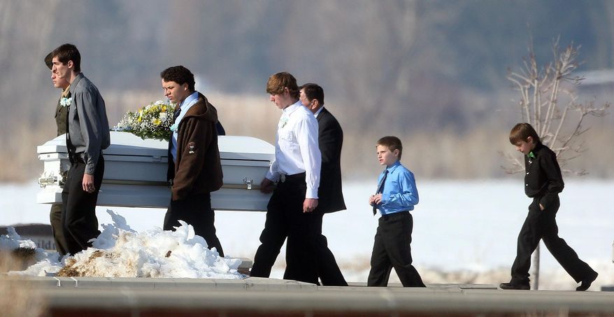 In a Wednesday, Jan. 22, 2014 photo, the third of four caskets containing a member of the Boren family is carried to the interment after the funeral service at Lindquist's Mortuary in Layton, Utah. Police say Lindon officer Joshua Boren shot the four dead before committing suicide Jan. 16. (AP Photo/Deseret News, Laura Seitz) SALT LAKE TRIBUNE OUT; MAGS OUT; MANDATORY CREDIT.