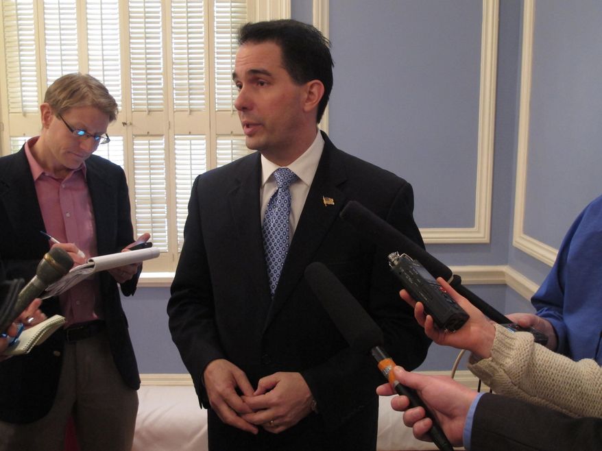 Gov. Scott Walker defends his $504 million tax cut plan, saying he expects it to pass with bipartisan support, on Thursday, Jan. 23, 2014, in Madison, Wis. (AP Photo/Scott Bauer)