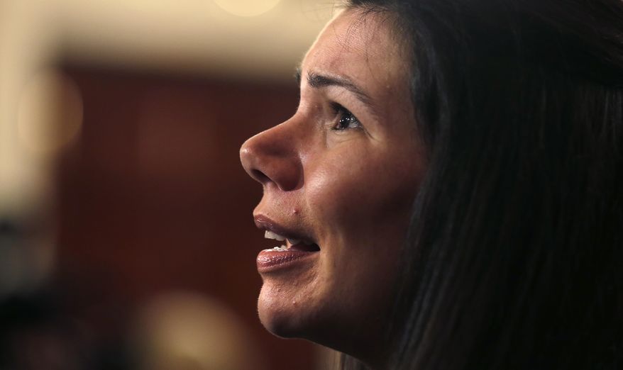 RETRANSMISSION TO CORRECT DAY AND DATE - Kellie Schaffer, the sister of murder victim Beth Brodie, talks with reporters following a news conference at the Statehouse in Boston, Thursday, Jan. 23, 2014. Mass. Senate Minority Leader Bruce Tarr and Mass. Sen. Barry Finegold, left, will introduce new legislation in response to a recent ruling from the state's highest court that sentencing juveniles convicted of murder to life without parole is unconstitutional. Tarr and Finegold's bill calls for a 35-year minimum term, before parole could be considered. (AP Photo/Charles Krupa)