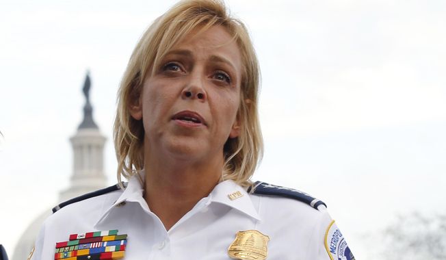 FILE - In this Oct. 3, 2013 file photo, Washington Police Chief Cathy Lanier speaks on Capitol Hill in Washington. Police officials in the nation’s capital have been facing recent questions about headline-making arrests _ not of hardened street criminals but of their own officers. In a single month, one District of Columbia police officer was accused of taking semi-nude pictures of a 15-year-old runaway and another was charged with running a prostitution operation involving teenage girls. A third was indicted on an attempted murder charge, accused of striking his wife in the head with a light fixture. (AP Photo/Molly Riley, File)