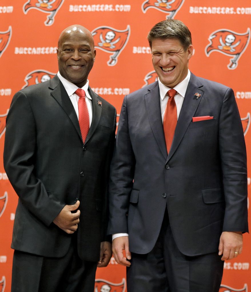 New Tampa Bay Buccaneers general manager Jason Licht, right, smiles as he poses for a photo with new head coach Lovie Smith during an NFL football news conference Thursday, Jan. 23, 2014, in Tampa, Fla. Licht becomes the fifth general manager in team history. He takes over a team that hasn't made the playoffs since 2007. (AP Photo/Chris O'Meara)