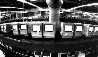 FILE - In this March 28, 1984, file photo, thousands of Apple Macintosh computers sit on double decked manufacturing lines. Friday, January 24, 2014, marks thirty years after the first Mac computer was introduced, sparking a revolution in computing and in publishing as people began creating fancy newsletters, brochures and other publications from their desktops. (AP Photo/Paul Sakuma, File)