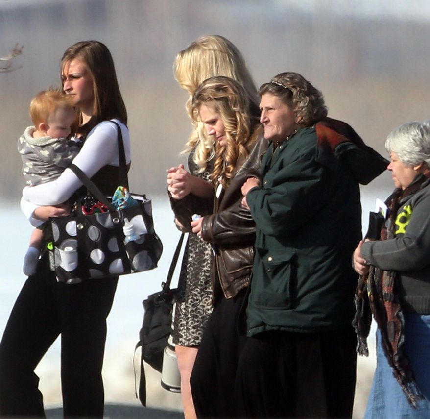 In a Wednesday, Jan. 22, 2014 photo, friends and family of the Boren family attend the funeral service for four of the family at Lindquist's Mortuary in Layton, Utah. Police say Lindon officer Joshua Boren shot the four dead before committing suicide Jan. 16. (AP Photo/Deseret News, Laura Seitz) SALT LAKE TRIBUNE OUT; MAGS OUT; MANDATORY CREDIT.