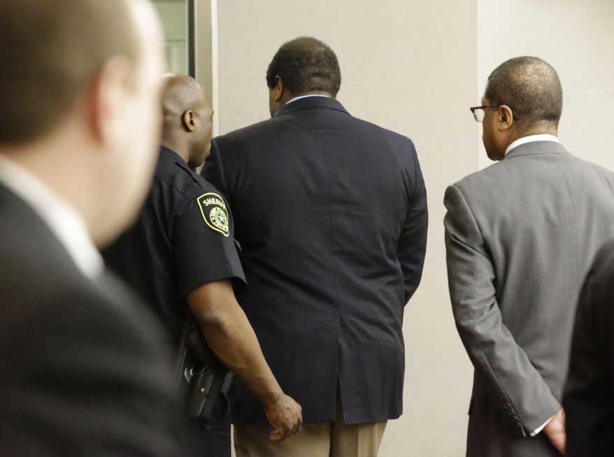 Former Dallas Cowboys NFL football player Josh Brent, center, is lead away from court into custody after his sentencing in his intoxication manslaughter trial Friday, Jan. 24, 2014, in Dallas. Brent was sentenced to 180 days in jail and 10 years of probation for a drunken car crash that killed his friend and teammate, Jerry Brown. He could have been sentenced to up to 20 years in prison. (AP Photo/Pool/LM Otero, Pool)