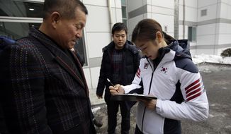 Kim Yuna, Vancouver gold medalist for the women&#39;s figure skating, signs her autograph for a fan prior to the inaugural ceremony of South Korean national team for the Sochi Winter Olympics in Seoul, South Korea, Thursday, Jan. 23, 2014. South Korea will send 64 athletes to Sochi which will be held from Feb. 7-23. (AP Photo/Lee Jin-man)