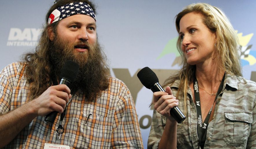 ** FILE ** This Feb. 24, 2013, file photo shows Willie Robertson, left, and Korie Robertson, of the reality TV show, &quot;Duck Dynasty,&quot; before the Daytona 500 NASCAR Sprint Cup Series auto race, at Daytona International Speedway in Daytona Beach, Fla. (AP Photo/Terry Renna, File)