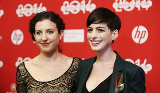 FILE - In this Mon., Jan. 20, 2014 file photo, writer and director Kate Barker-Froyland, left, and cast member Anne Hathaway, pose together at the premiere of the film &amp;quot;Song One&amp;quot; during the 2014 Sundance Film Festival, in Park City, Utah. (Photo by Danny Moloshok/Invision/AP, File)