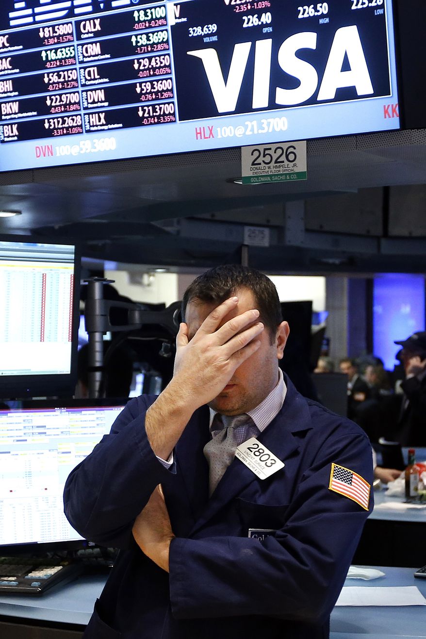 Specialist Vincent Surace works on the floor of the New York Stock Exchange Friday, Jan. 24, 2014. (AP Photo/Jason DeCrow)