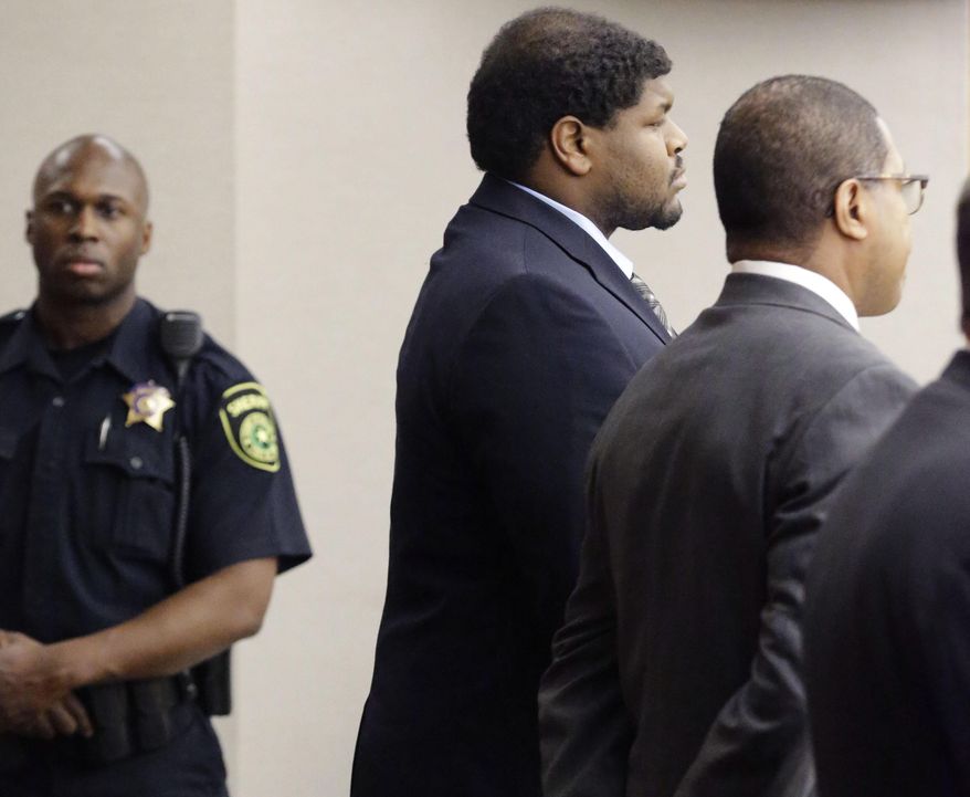 Josh Brent, center, former Dallas Cowboys NFL football player, stands with one of his lawyers Kevin Brooks while the punishment for his intoxication manslaughter conviction is read in court Friday, Jan. 24, 2014, in Dallas. Brent was sentenced to 180 days in jail and 10 years of probation for a drunken car crash that killed his friend and teammate, Jerry Brown. (AP Photo/Pool/LM Otero, Pool)