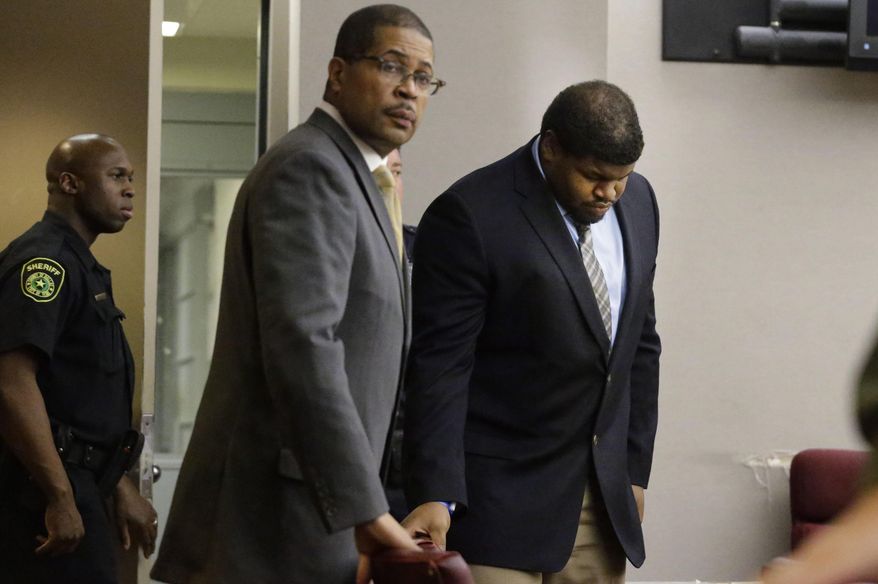 Josh Brent, center, former Dallas Cowboys NFL football player, enters the court with one of his lawyers Kevin Brooks for sentencing in Brent's intoxication manslaughter trialFriday, Jan. 24, 2014, in Dallas. Brent was sentenced to 180 days in jail and 10 years of probation for a drunken car crash that killed his friend and teammate, Jerry Brown. (AP Photo/Pool/LM Otero, Pool)