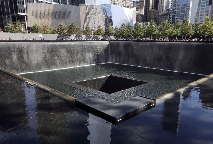 FILE - In this Sept. 6, 2013, file photo, The National September 11 Museum is seen beyond the North Pool at the memorial in New York. New York City Mayor Bill de Blasio called upon the federal government Wednesday, Jan. 15, 2014, to help support the Sept. 11 museum at the World Trade Center, which is set to open this spring after years of delays but is potentially facing budget shortfalls. (AP Photo/Mary Altaffer, File)