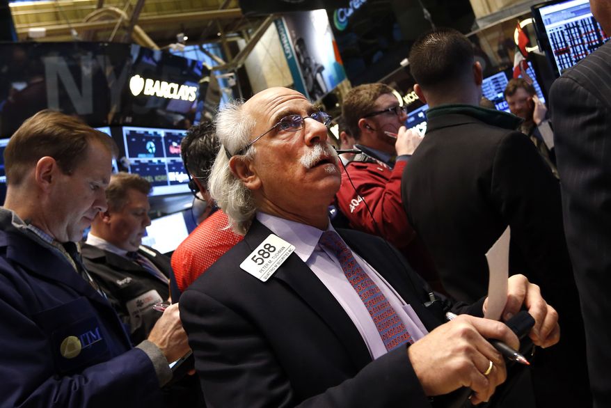 Trader Peter Tuchman works on the floor of the New York Stock Exchange Friday, Jan. 24, 2014. (AP Photo/Jason DeCrow)