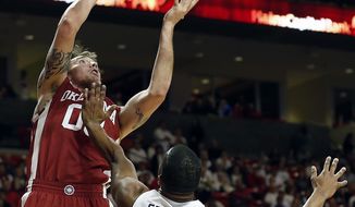Oklahoma&#x27;s Ryan Spangler shoots under pressure from Texas Tech&#x27;s Toddrick Gotcher (20) during an NCAA college basketball game in Lubbock, Texas, Saturday, Jan. 25, 2014. (AP Photo/The Avalanche-Journal, Tori Eichberger)