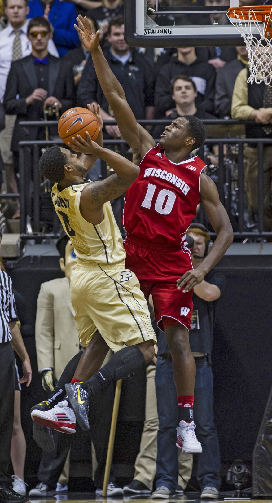 Wisconsin's Nigel Hayes (10) goes up to block the shot of Purdue's Terone Johnson (0) in the first half of an NCAA college basketball game, Saturday, Jan. 25, 2014, in West Lafayette, Ind. (AP Photo/Doug McSchooler)