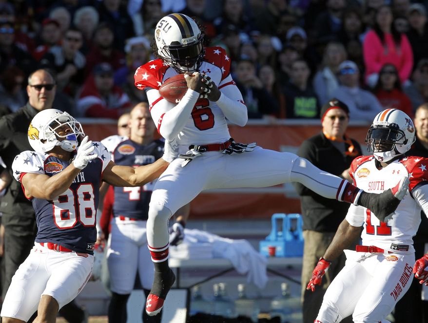 South safety Craig Loston, of LSU, intercepts a pass intended for North receiver Robert Herron, of Wyoming, during the first half of the Senior Bowl college football game on Saturday, Jan. 25, 2014, in Mobile, Ala. (AP Photo/Butch Dill)