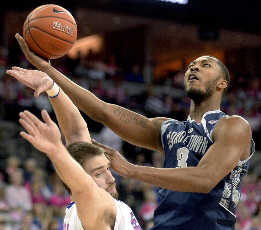 Georgetown forward Mikael Hopkins (3) gets fouled by Creighton forward Ethan Wragge as he drives to the basket during the first half of an NCAA college basketball game in Omaha, Neb., on Saturday, Jan. 25, 2014. (AP Photo/Francis Gardler)