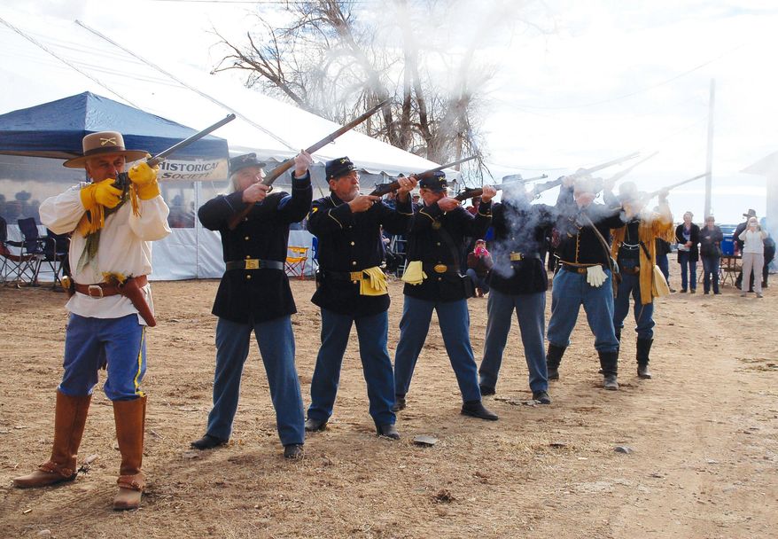 The Prescott Regulators conducted an 18-gun salute Wednesday, Jan. 22, 2014 to re-enact the welcome received by Gov. John Goodwin when he arrived at Del Rio Springs near current Chino Valley, Ariz., on Jan. 22, 1864. Goodwin was the first governor of Arizona. (AP Photo/The Daily Courier, Joanna Dodder Nellans)