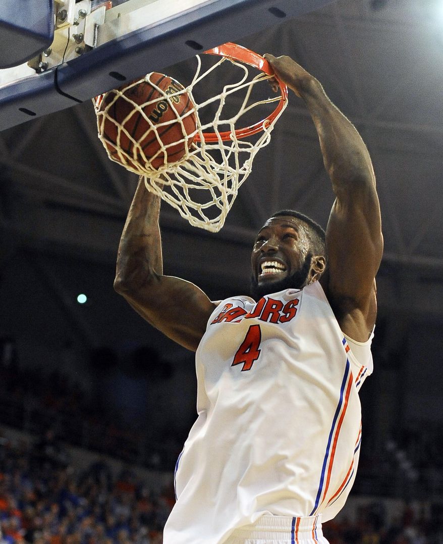 Florida center Patric Young (4) dunks during the first half of an NCAA college basketball game against Tennessee Saturday, Jan. 25, 2014 in Gainesville, Fla. (AP Photo/Phil Sandlin)