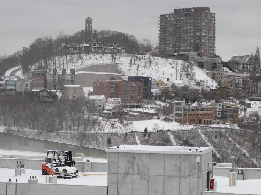 The Cincinnati neighborhood of Mount Adams is shown blanketed in snow Saturday, Jan. 25, 2014, after fresh snow fell across Ohio overnight Saturday and was continuing in the morning, creating hazardous driving conditions that caused several crashes. (AP Photo/Amanda Lee Myers)