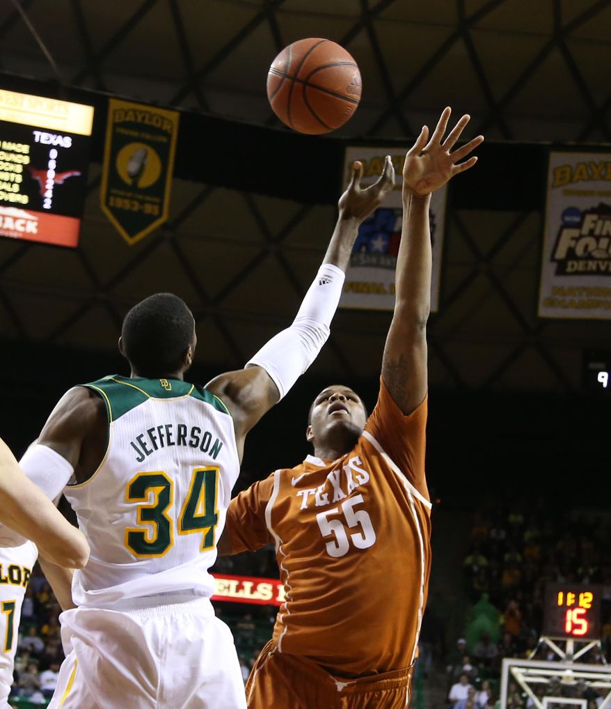 Texas center Cameron Ridley (55) reaches for a rebound with Baylor forward Cory Jefferson (34) in the first half of a NCAA college basketball game, Saturday, Jan. 25, 2014, in Waco, Texas. (AP Photo/Waco Tribune Herald, Rod Aydelotte)