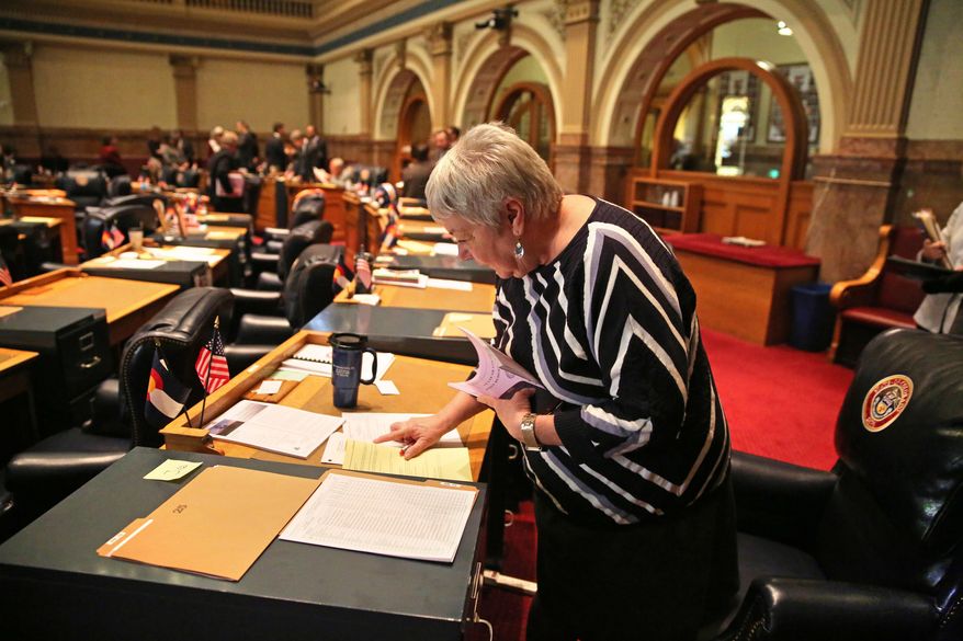 In this Jan. 22, 2014 photo, Colorado Democratic state senator Mary Hodge does some reading at her desk inside the chambers of the Colorado State Senate, at the Capitol, in Denver. Sen. Hodge has proposed a bill requiring better informing landowners and buyers about their property rights, which often doesn't include mineral rights below the surface. (AP Photo/Brennan Linsley)