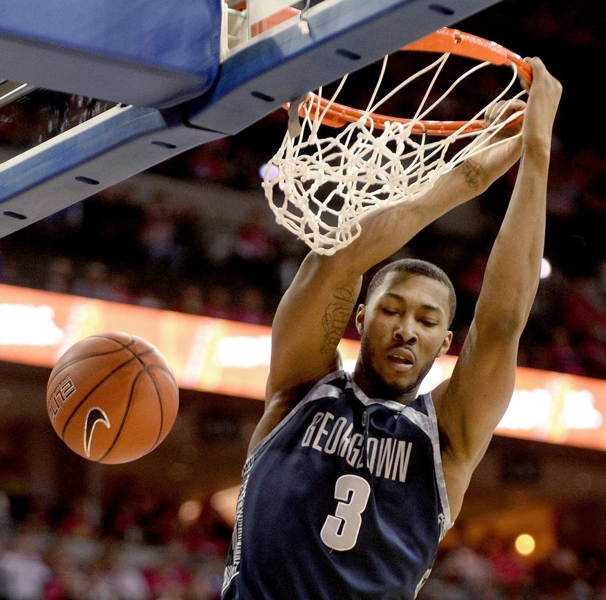 Georgetown forward Mikael Hopkins dunks during the first half of an NCAA college basketball game in Omaha, Neb., Saturday, Jan. 25, 2014. (AP Photo/Francis Gardler)