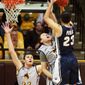 Nevada&#x27;s Michael Perez puts a shot over Wyoming&#x27;s Riley Grabau and Larry Nance, Jr., left, during an NCAA college basketball game Saturday, Jan. 25, 2014, at the Arena-Auditorium in Laramie, Wyo. Wyoming defeated Nevada 64-62 in overtime. (AP Photo/The Casper Star-Tribune, Alan Rogers)