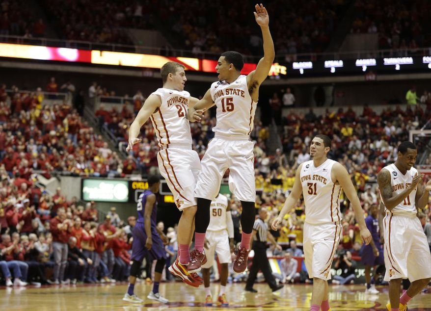 Iowa State guard Matt Thomas, left, celebrates with teammate Naz Long (15) after making a 3-point basket during the first half of an NCAA college basketball game against Kansas State, Saturday, Jan. 25, 2014, in Ames, Iowa. (AP Photo/Charlie Neibergall)